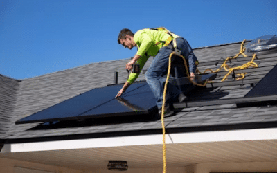 Guy installing solar panel on the roof